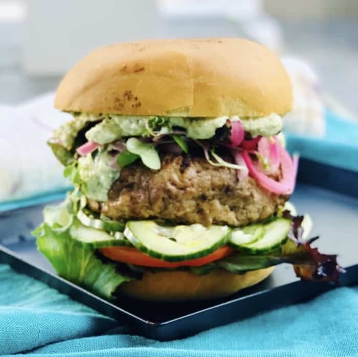 burger with lettuce and fixings on a bun
